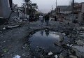 На месте взрыва машины, начиненной взрывчаткой, в районе Новый Багдад