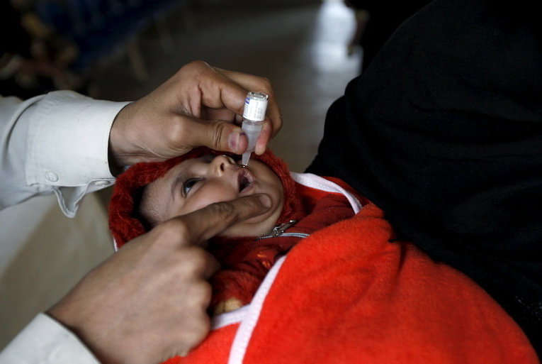 Ребенок получает вакцину против полиомиелита в Карачи, Пакистан