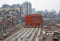 Перемещение старого здания для освобождения места для новых сооружений в городе Ухань, Китай
