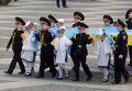 Кадеты и школьницы держат флаг Украины во время создания живого тризуба в Киеве
