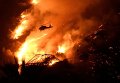 Пожарный вертолет борется с крупным пожаром, охватившим часть штата Калифорния.