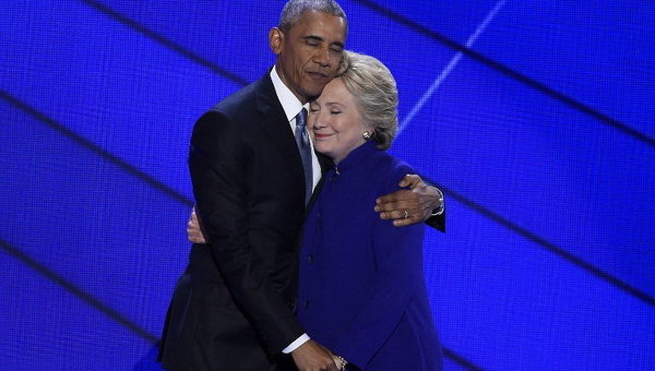 Президент США Барак Обама и кандидат в президенты США Хиллари Клинтон обнимаются на сцене во время Национального съезда Демократической партии