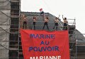 Активистки FEMEN развернули плакат у участка, где будет голосовать Ле Пен