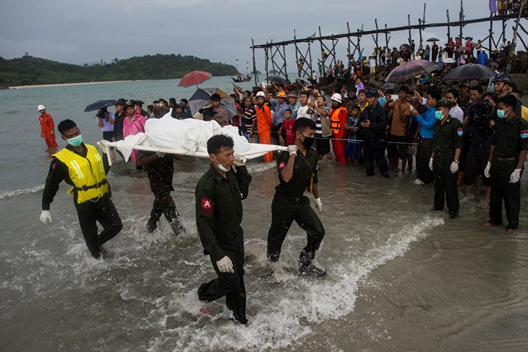 Военные выносят тело погибшего во время крушения военного самолета в Мьянме
