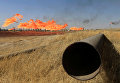 Пламя из факелов на нефтяных месторождениях в Киркуке, Ирак.