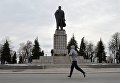 Мужчина бежит мимо памятника В.И. Ленину на площади Ленина в Ульяновске.