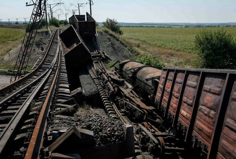 Вагоны на разрушенном железнодорожном мосту на главной дороге, ведущей к  Донецку