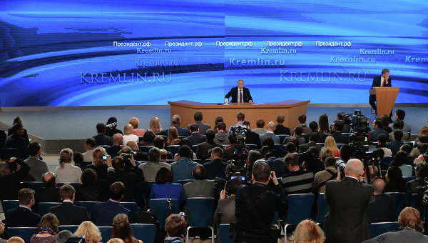 Владимир Путин (в центре на дальнем плане) на десятой большой ежегодной пресс-конференции