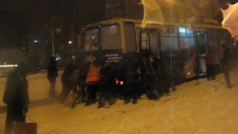 Троллейбус толкают в Запорожье, чтобы вытащить из сугробов