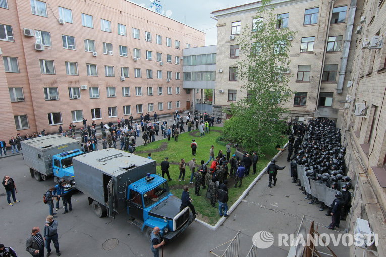 Ополченцы и сотрудники милиции во дворе областной администрации в Луганске, взятой под контроль сторонниками федерализации.