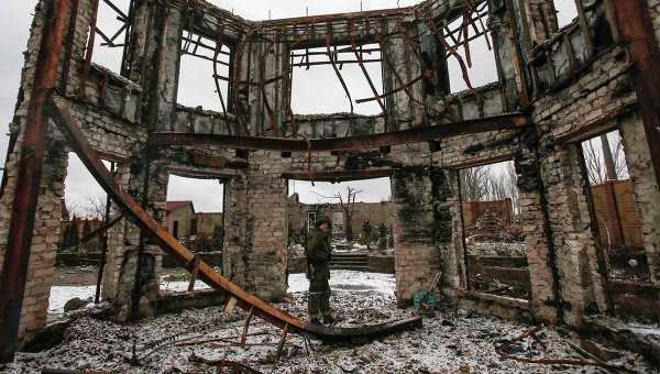 Ополченец на фоне разрушенного здания в Углегорске