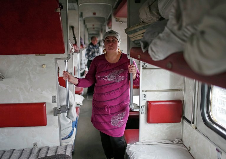 Беженка в вагоне поезда, где она сейчас живет, недалеко от железнодорожного вокзала в Славянске