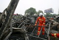 Пожарные убирают мусор после пожара в реабилитационном центре для пожилых людей в селе провинции Хэнань, Китай