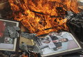 Портрет президента Мексики Энрике Пенья Ньето на куче горящих документов, после того, как члены профсоюза учителей CNTE разгромили местное отделение Институционно-революционной партии (PRI) в Оахака, Мексика