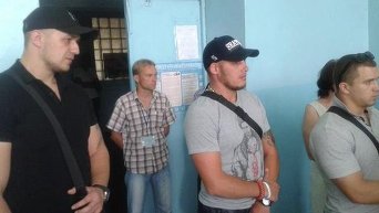 Мужчины охраняют наблюдателя на одном из избирательном участке в Чернигове
