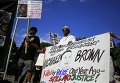 Протесты в Фергюсоне в знак памяти Майкла Брауна - 18-летнего афроамериканца, застреленного белым полицейским