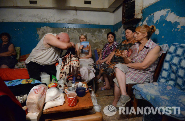 Пожилые жители Иловайска в подвале жилого дома спасаются от обстрела