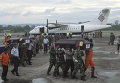 Индонезийские силы безопасности и спасатели несут гробы с останками пассажиров потерпевшего крушение самолета Air Trigana в  аэропорту, недалеко от Джаяпура, провинции Папуа, Индонезия