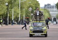 Британский комик Роуэн Аткинсон в роли мистера Бина едет на машине в центре Лондона