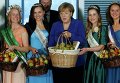 Канцлер ФРГ Ангела Меркель позирует с яблочными и цветочными королевами, которые представили яблоки из разных садов Германии