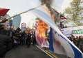 Студенты жгут флаги США, Израиля и Британии у бывшего посольства США в Тегеране